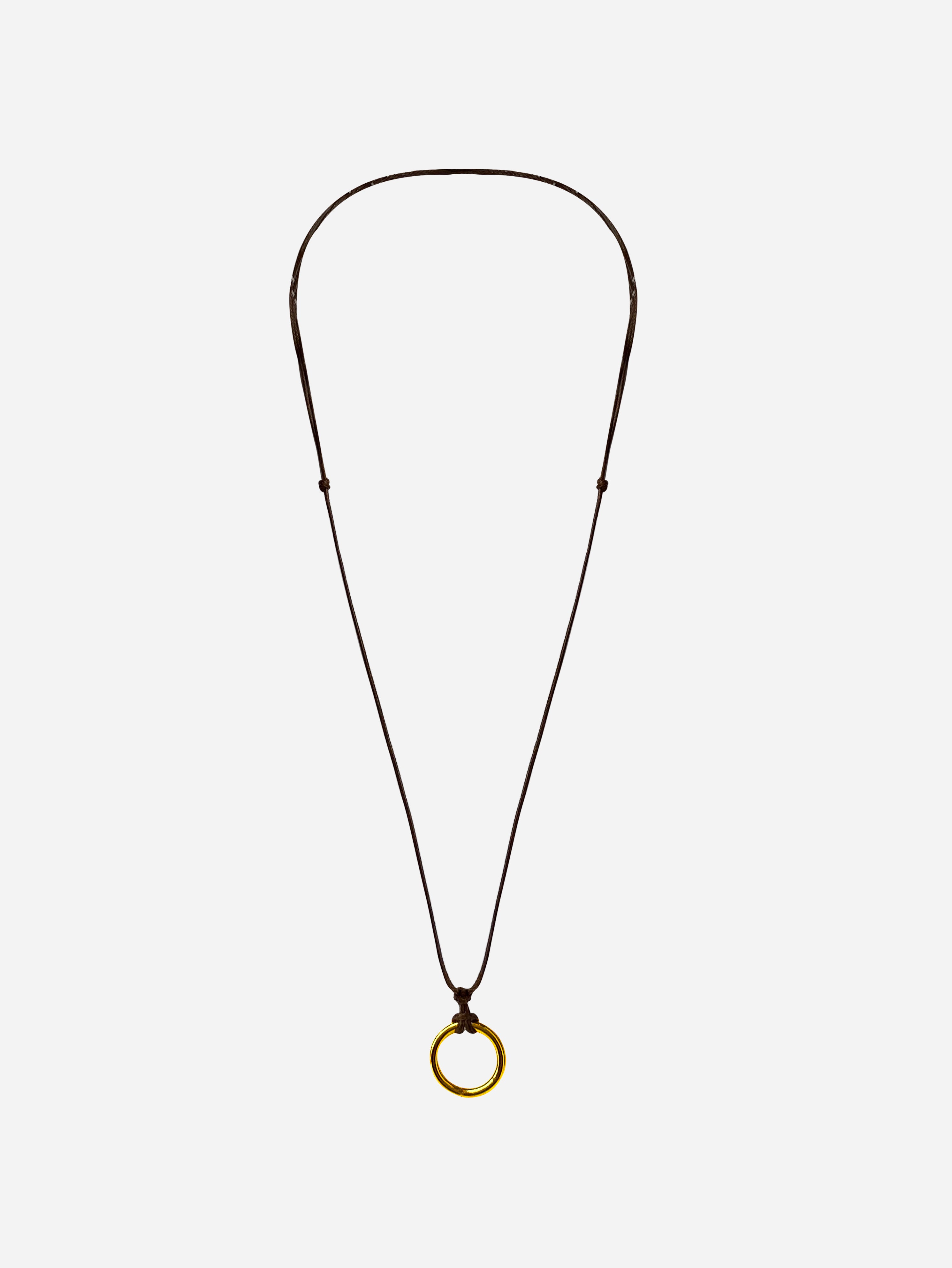 floating black string with small gold ring in the middle with white background